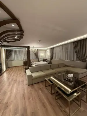 a living room with a couch and a table at amazing rooftop studio at abdoun 702 in Amman