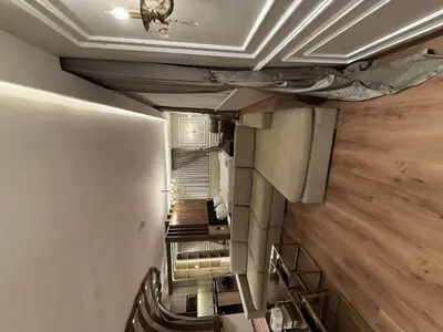a room with a staircase with a ceiling and wooden floors at amazing rooftop studio at abdoun 702 in Amman