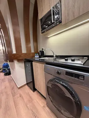 a kitchen with a washing machine and a sink at amazing rooftop studio at abdoun 702 in Amman