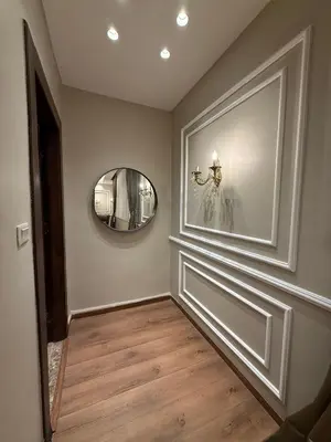 a hallway with a door and a mirror at amazing rooftop studio at abdoun 702 in Amman