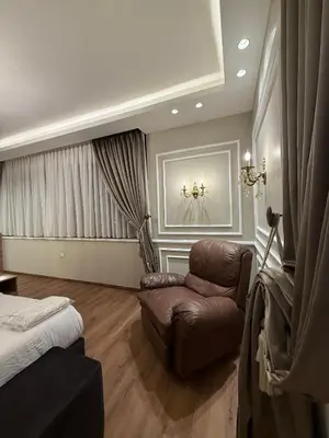 a living room with a couch and a bed at amazing rooftop studio at abdoun 702 in Amman