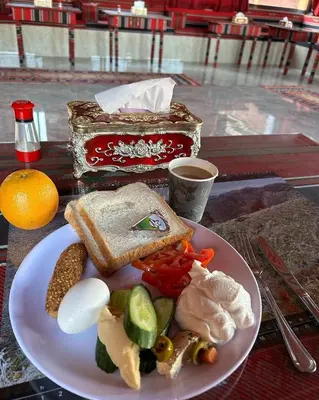 a plate of food with bread and vegetables on a table at Desert Time in Wadi Rum