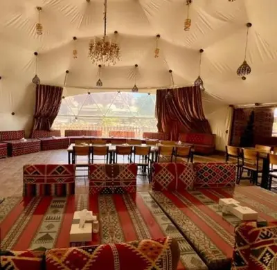 a room with a tent with a table and chairs at Wadi Rum Salem in Wadi Rum