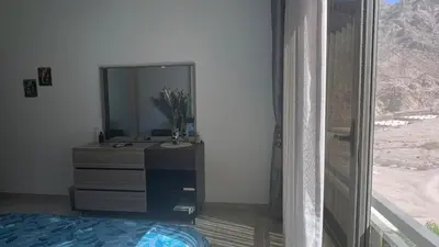 a bathroom with a sink and a mirror in a room at Luxury Suite in Aqaba AlRaha Village Marsa Zayed in Aqaba