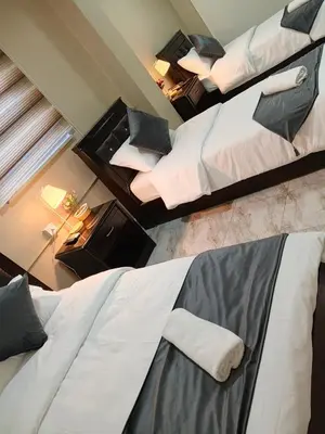 two twin beds in a room with at Kahraman Amman Hotel in Amman