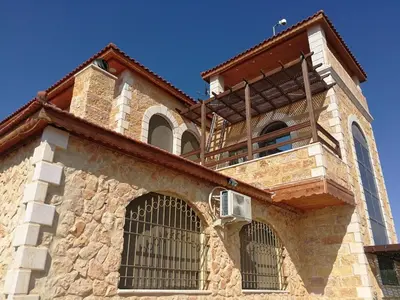 a building with a balcony on top of it at Green Hills in Ajloun
