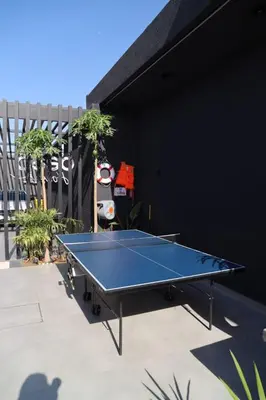 a ping pong table sitting on top of a patio at Deep House Villas in Al Rama