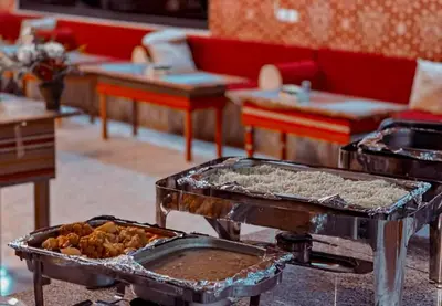 two trays of food on a table in a room at Camb wadi Rum in Disah