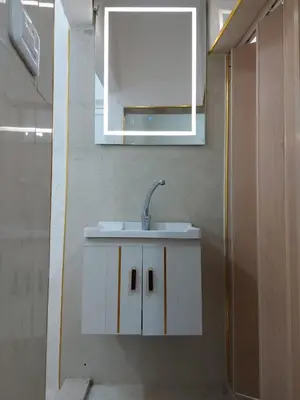 a bathroom with a white sink and a mirror at Small huose in Amman