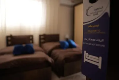 a room with two beds with blue pillows on them at المتطورة للشقق الفندقية in Amman