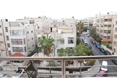a view of a city from a balcony at المتطورة للشقق الفندقية in Amman