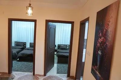a room with two beds and a hallway with two mirrors at المتطورة للشقق الفندقية in Amman
