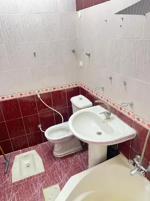 a bathroom with a toilet and a sink at دار الخير للشقق المفروشة in Al Mafraq