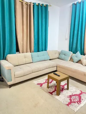 a living room with a couch and a coffee table at دار الخير للشقق المفروشة in Al Mafraq