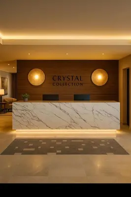 a lobby with a marble counter in front of a sign at Crystal Collection Hotel in Amman
