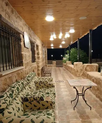 a living room with couches and a table in a building at The modern village in ‘Ayn Amūn