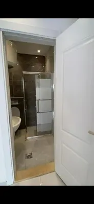 a bathroom with a shower and a sink and a toilet at 2 bedroom studio - Fully furnished in Irbid