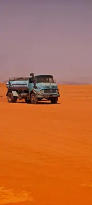 a jeep parked in the middle of a desert at Bedouin Horizons in Wadi Rum