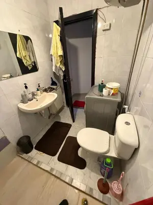 a small bathroom with a toilet and a sink at Al Jubaiha cozy studio 2 in Amman
