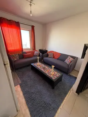 a living room with two couches and a coffee table at Al Jubaiha cozy studio 2 in Amman