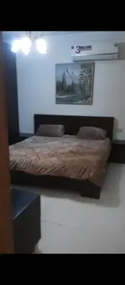 a bed in a bedroom with a picture on the wall at عمان شارع مكه in Amman