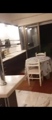 a room with a table and a white chair at عمان شارع مكه in Amman