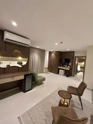 a large living room with a couch and a bed at AL Hyatt Relax Hotel in Aqaba