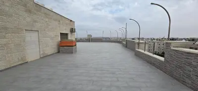 a walkway on top of a building with street lights at Irbid irbid alrazi st in Irbid
