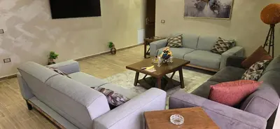 a living room with couches and a table at Irbid irbid alrazi st in Irbid
