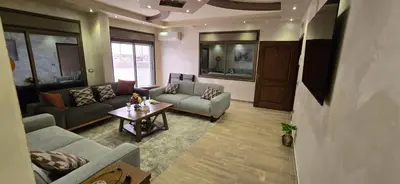 a living room with two couches and a table at Irbid irbid alrazi st in Irbid