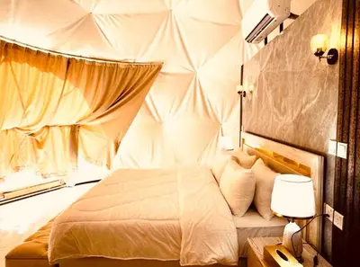 a bedroom with a large bed in a room at Wadi Rum Emerald Camp in Wadi Rum