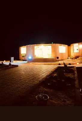 a building lit up at night with at Wadi Rum Emerald Camp in Wadi Rum