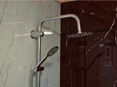 a shower with a shower head in a bathroom at Wadi Rum Emerald Camp in Wadi Rum