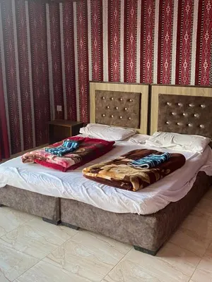 a bed with two pillows on it in a bedroom at Kingdom of the Stars, Wadi Rum in Aqaba