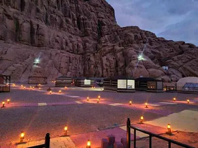 a desert with a mountain in the background at Wadi Rum cloud in Ma‘ān