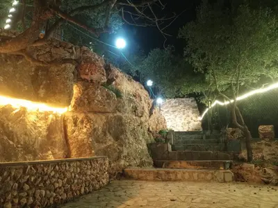 a stone wall and stairs at night with lights at Sultan Chalet Ajloun شاليه السلطان in Ajloun