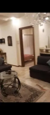 a living room with a couch and a table at شقه مفروشه بالكامل في عمان شارع مكه ضاحيه الأمير راشد in Amman