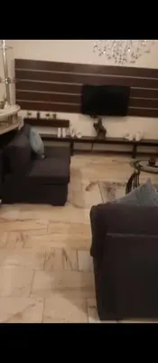 a living room with two couches and a wooden floor at شقه مفروشه بالكامل في عمان شارع مكه ضاحيه الأمير راشد in Amman