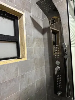 a shower in a bathroom with a window at RoofTOP SPORTCITY in Amman