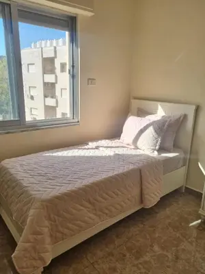 a bedroom with a bed with a large window at Elegant 2 bedrooms in 4th circle-Diplomatic Area in Amman