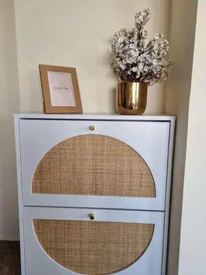 a dresser with a vase of flowers on top of it at Elegant 2 bedrooms in 4th circle-Diplomatic Area in Amman