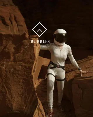 a man in a wetsuit standing on a rock at BUBBLES LUXURY CAMp in Wadi Rum