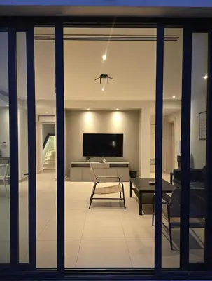 a living room with a tv and a table at RV Villas Deadsea in Sowayma