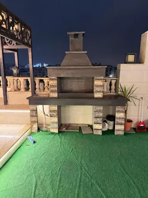 a building with a green floor on a roof at Rooftop sport city in Amman