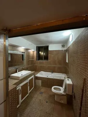 a bathroom with a tub and a toilet and a sink at Cozy Studio 1 Central Amman Near Rainbow Street in Amman