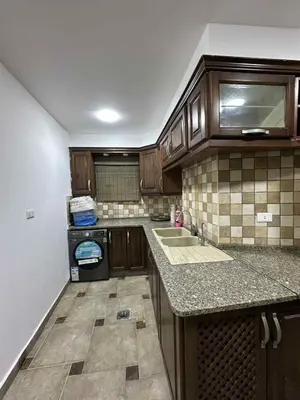 a small kitchen with a sink and a stove at Cozy Studio 1 Central Amman Near Rainbow Street in Amman