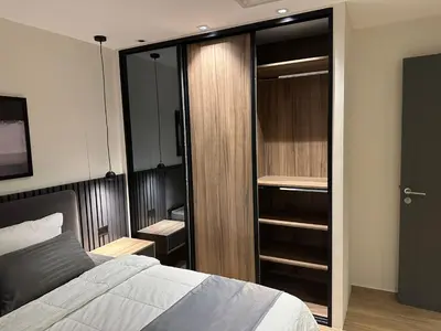 a bedroom with a bed and a closet at Cozy Modern Apartment Damac Abdali in Amman