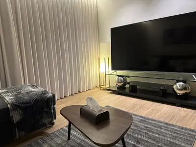 a living room with a large flat screen tv at Cozy Modern Apartment Damac Abdali in Amman