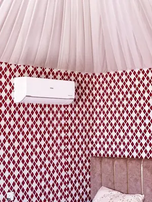a bedroom with a wall with a wall mounted speaker at Oasis of Civilizations Camp in Wadi Rum