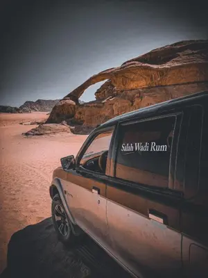 a truck parked on the sand in the desert at Oasis of Civilizations Camp in Wadi Rum